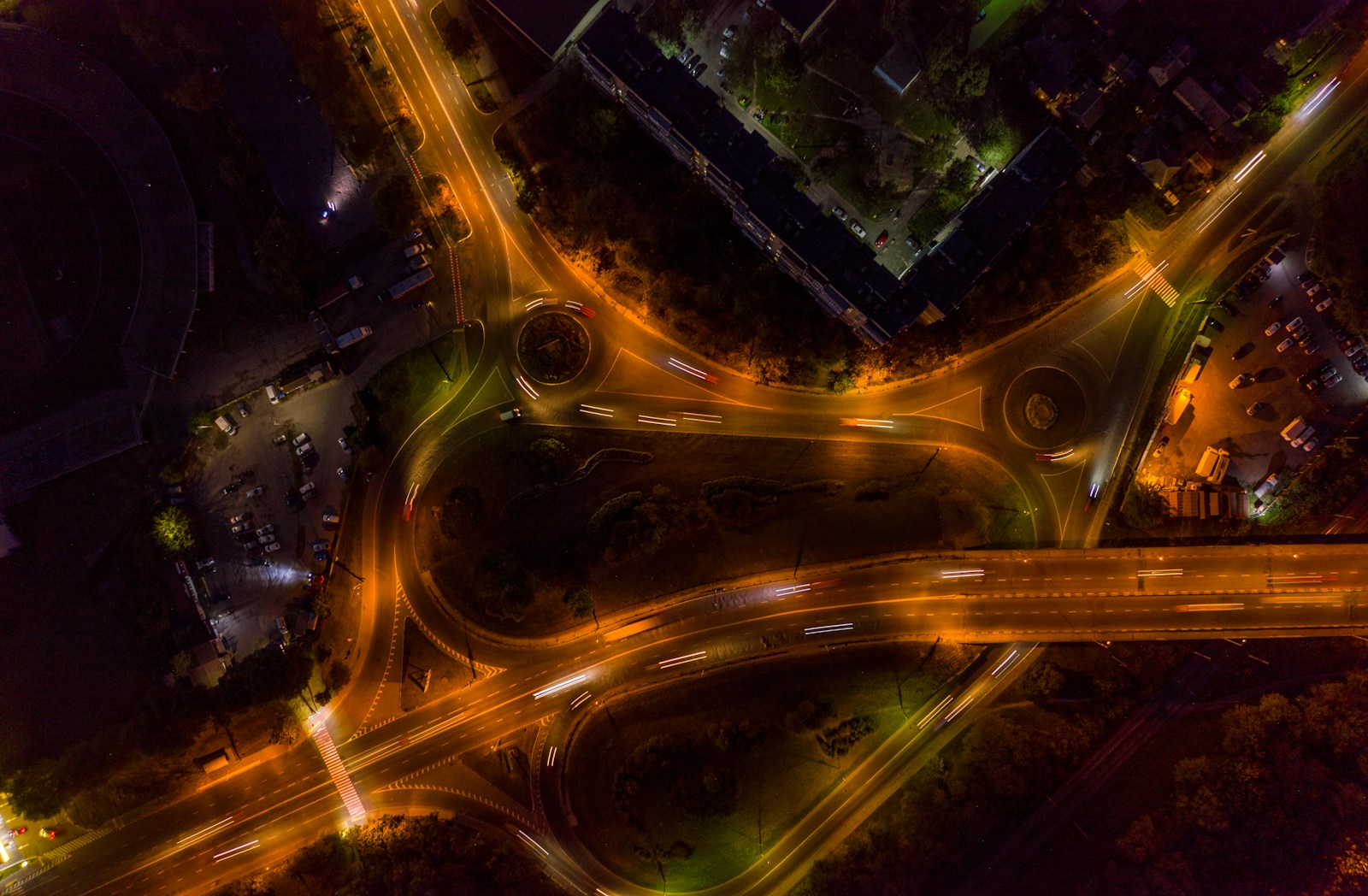 Night aerial of an illuminated highway interchange, used as the figure for the highway concept.